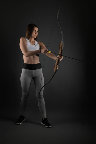Attractive Female Practicing Archery  - Foto, Bild