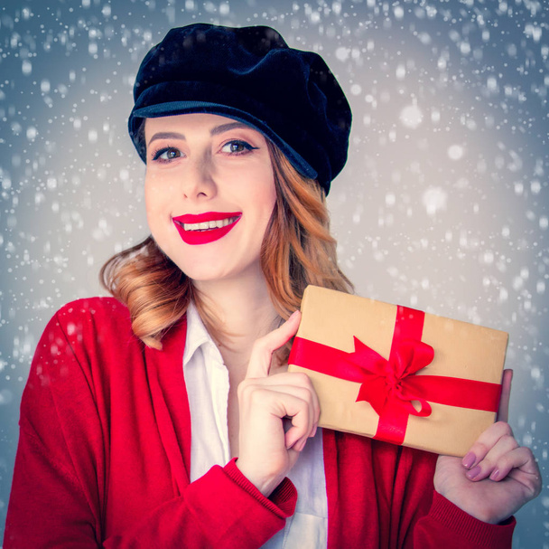woman in red cardigan and hat with gift box - Photo, Image