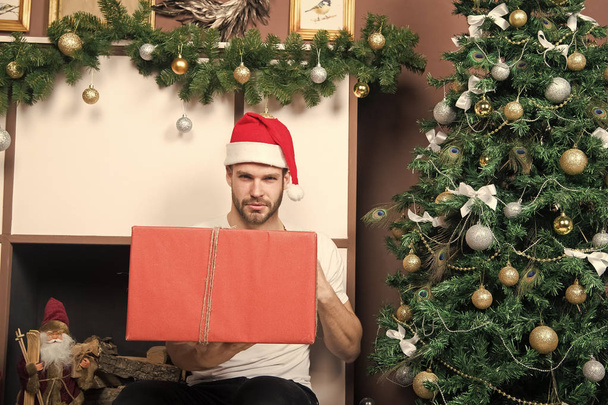 Man with present box at Christmas tree - Photo, Image