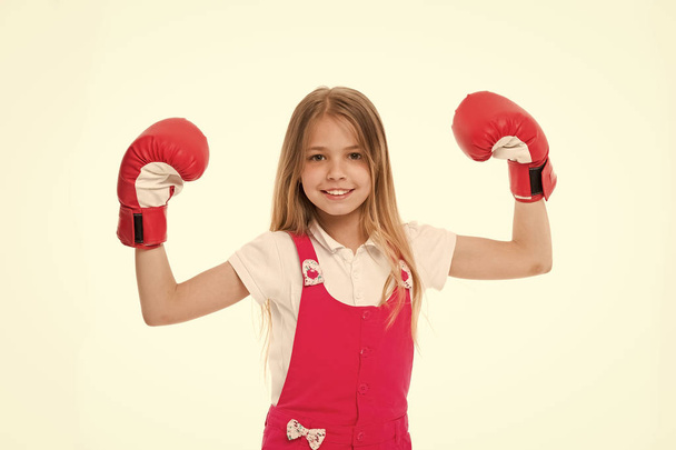 Kid athlete show power. Happy child in boxing gloves isolated on white. Little girl smile before training or workout. Childhood and childcare. Sport activity and energy - Zdjęcie, obraz