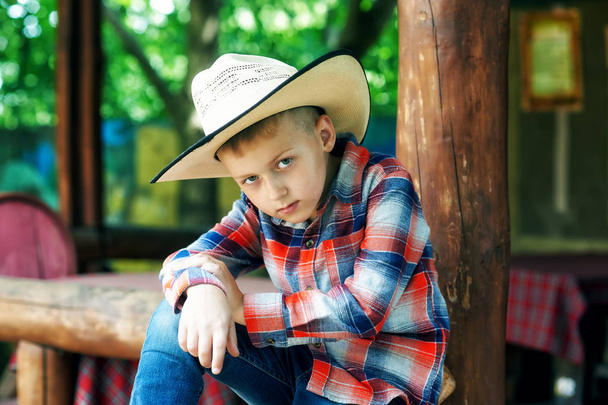 portrait of a boy in a hat on a ranch - Photo, Image