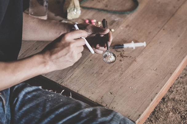 Man taking heroin, cocaine or other narcotic substance,  Drug abuse and addiction concept,  26 June International Day Against Drug abuse. - Fotó, kép