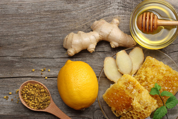 healthy background. honey, honeycomb, lemon, ginger on old wooden table. Top view with copy space - Fotoğraf, Görsel