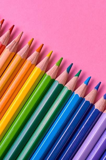 Color pencils on pink pastel background, close up. Set of colorful pencils, copy space. Crayons. Top view, flat lay. Back to school, college concept. Abstract background - Foto, afbeelding