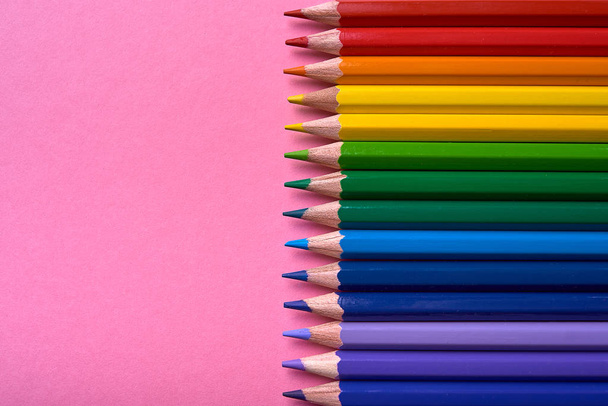 Colorful pencils of rainbow colors on pink pastel background, close up. Set of colorful pencils, copy space. Crayons. Top view, flat lay. Back to school, college concept. Abstract background - Fotó, kép