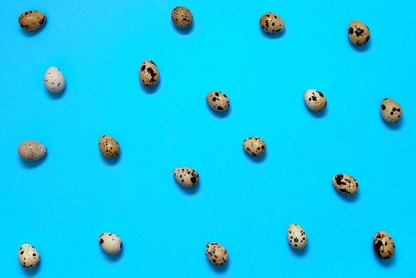 Quail eggs on blue background, copy space. Healthy food concept. Top view, flat lay. Easter eggs. Happy Easter concept - Valokuva, kuva