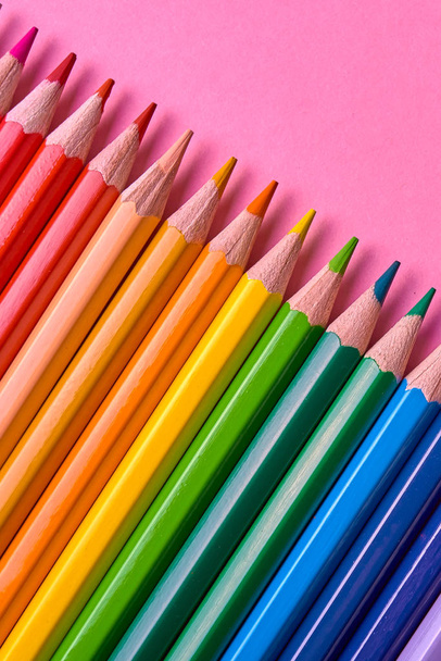 Color pencils on pink pastel background, close up. Set of colorful pencils, copy space. Crayons. Top view, flat lay. Back to school, college concept. Abstract background - Fotografie, Obrázek