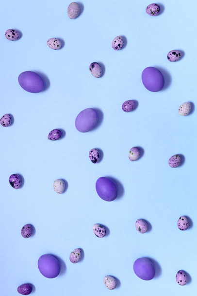 Violet hen and quail easter eggs on blue background, copy space. Healthy food concept. Top view, flat lay. Happy Easter concept - Fotoğraf, Görsel