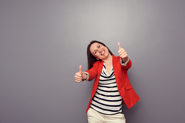 attractive happy girl showing thumbs up - Photo, Image