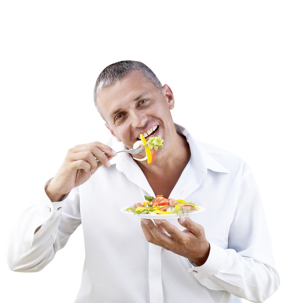 Adult man eating fresh vegetable salad - Fotoğraf, Görsel