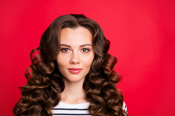 Close up portrait of attractive smiling happy stylish modern her she girl with long wave hair wearing casual striped pullover isolated on red bright vivid background - Valokuva, kuva