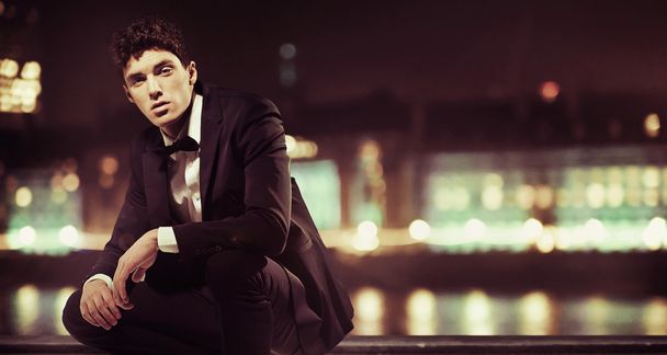 Stylish man with night town over the background - Фото, зображення