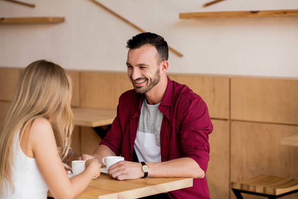 Cute couple having coffee together in cafe - Photo, Image