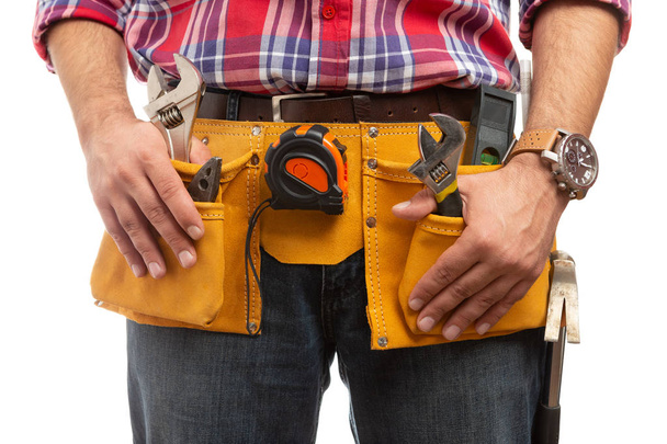 Constructor holding both hands on tool belt on waist isolated on white studio background - Photo, Image