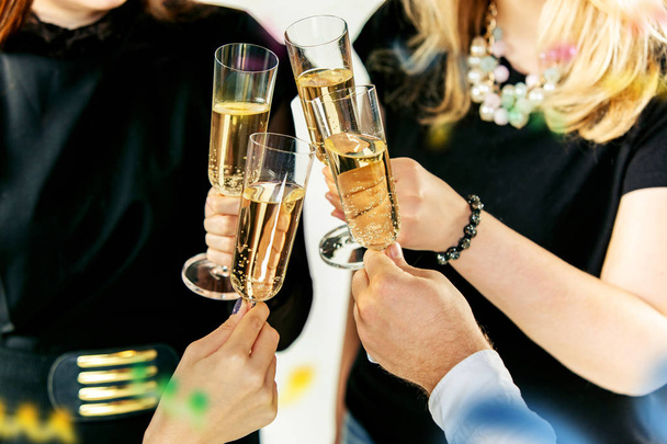 Feiern. Hände halten die Gläser mit Champagner und Wein und stoßen an. - Foto, Bild