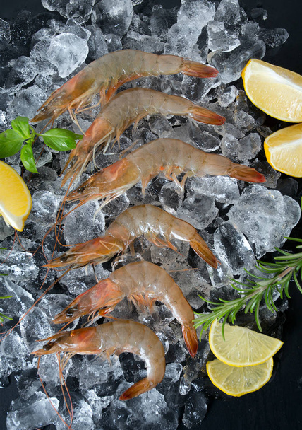 resh raw prawns on dark gray kitchen table - Zdjęcie, obraz