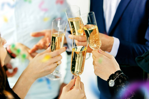 Celebration. Hands holding the glasses of champagne and wine making a toast. - Φωτογραφία, εικόνα