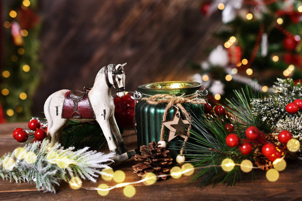 christmas decoration with rocking horse and candle lantern on wooden table  - Fotografie, Obrázek