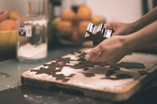 female hands making Gingerbread Cookies in kitchen - Фото, зображення