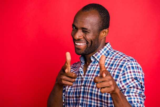 Portrait of nice handsome attractive cheerful positive guy wearing checked shirt pointing at you two forefingers inviting to party isolated over bright vivid shine red background - Foto, immagini