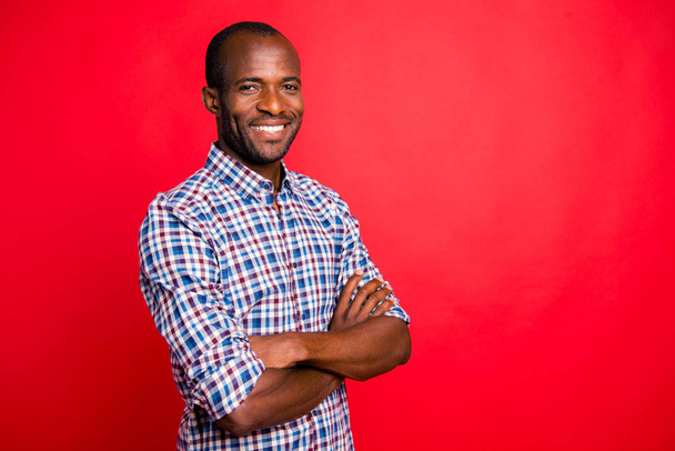 Profile side view portrait of nice handsome well-groomed trendy attractive cheerful positive cheery guy wearing checked shirt beaming smile isolated over bright vivid shine red background - Foto, Imagem