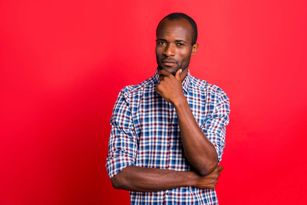 Portrait of nice handsome attractive calm candid guy wearing checked shirt touching chin isolated over bright vivid shine red background - Valokuva, kuva