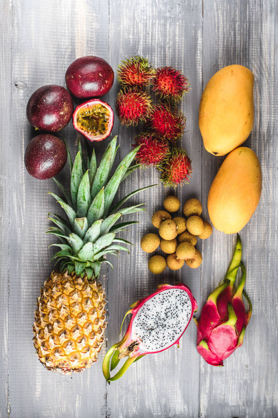 Set of exotic fruits. Assorted tropical fruits of pineapple, rambutan, passion fruit, mango, dragon fruit, longan - 写真・画像