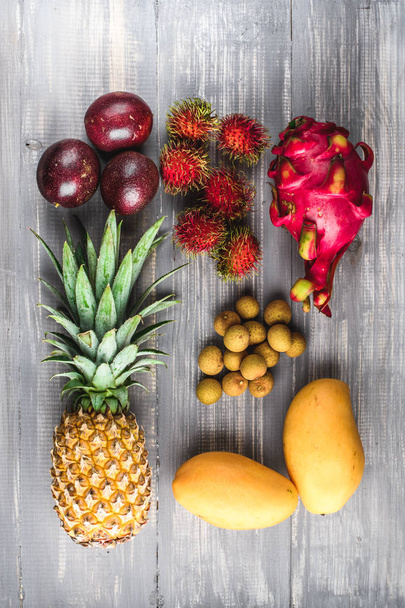 Set of exotic fruits. Assorted tropical fruits of pineapple, rambutan, passion fruit, mango, dragon fruit, longan - Фото, зображення