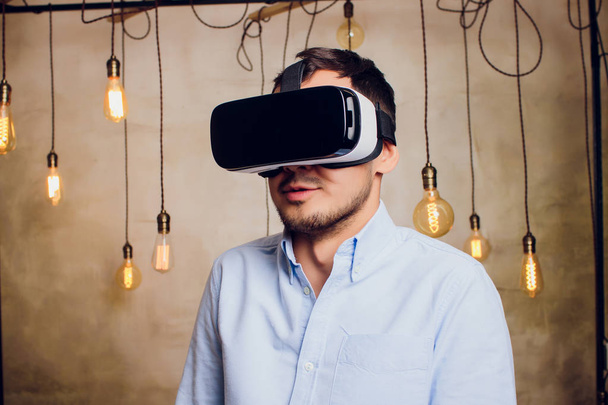 Amazed man looking in a VR goggles and gesturing. - Photo, image
