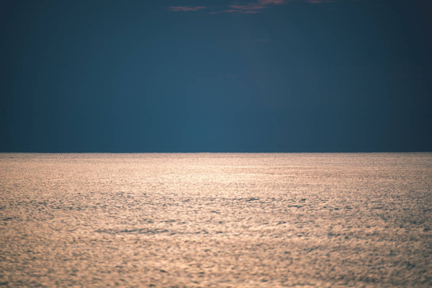 beautiful calm seascape under clear sky at sunset - Photo, Image