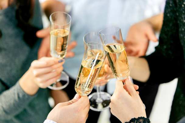 Celebration. Hands holding the glasses of champagne and wine making a toast. - Φωτογραφία, εικόνα
