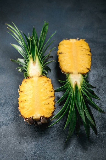 Pineapple exotic fruit from tropical countries on concrete table. Cutting pulp - Zdjęcie, obraz