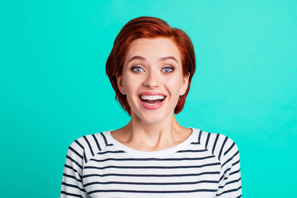 Close-up portrait of nice charming attractive lovely cheerful optimistic red-haired lady in striped pullover isolated over bright vivid shine green turquoise background - Foto, afbeelding