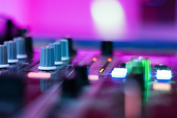 Dj mixes the track in the nightclub at a party. depth of field. closeup. - Foto, Imagen