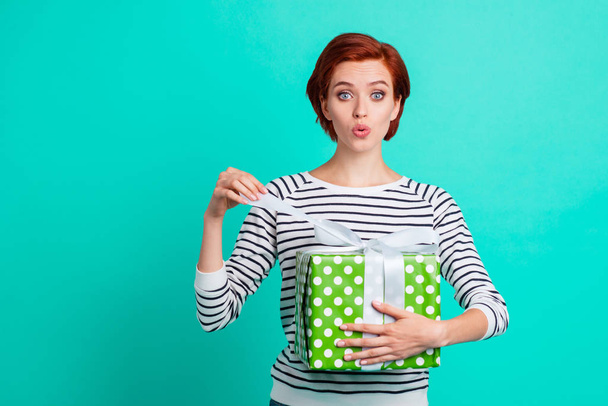 Close up portrait of attractive beautiful she her lady holding large gift box in hands unboxing it cunning hope nobody see it wearing white striped sweater isolated on teal background - Fotoğraf, Görsel