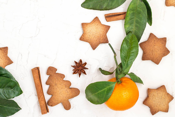 Border of Christmas star cookies with spices and mandarin on white background with copyspace. Top view - Foto, immagini