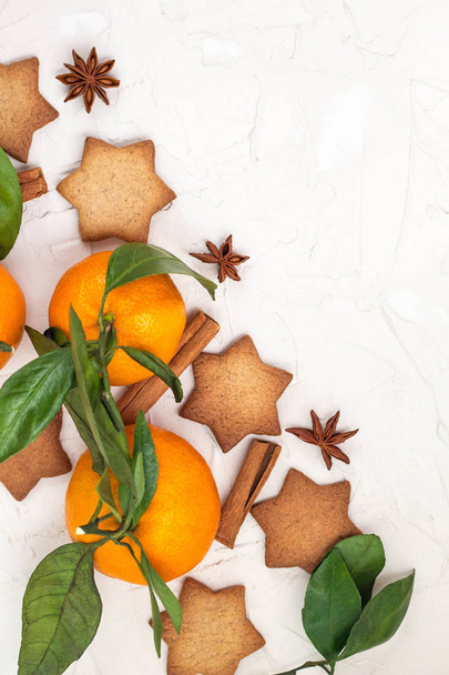 Border of Christmas star cookies with spices and mandarin on white background with copyspace. Top view - Photo, Image