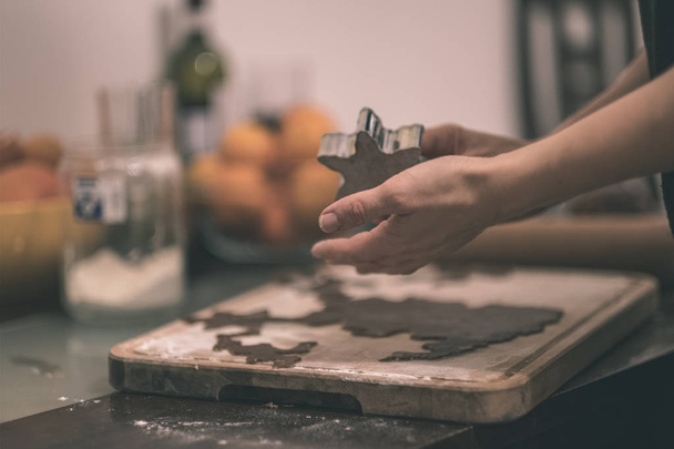 female hands making Gingerbread Cookies in kitchen - Photo, image
