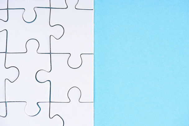 full frame of white puzzles arrangement on blue backdrop - 写真・画像