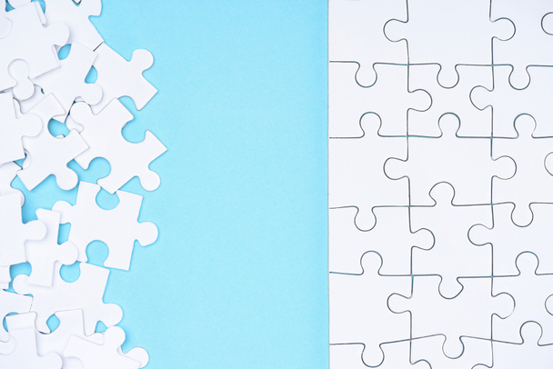 full frame of white puzzles arrangement on blue backdrop - Фото, изображение