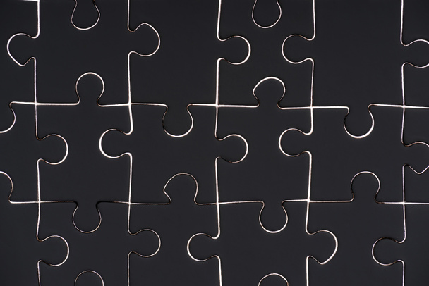 full frame of black puzzle pieces background - Foto, Imagem