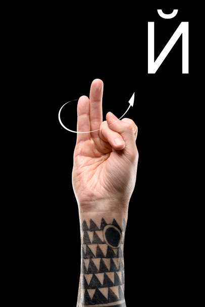 tattooed hand showing cyrillic alphabet, deaf and dumb language, isolated on black - Photo, image