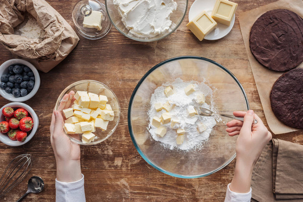 top view of woman mixing ingredients and preparing dough for homemade cake  - Photo, Image