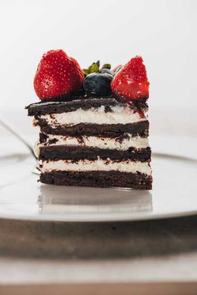 piece of delicious whoopie pie cake with fresh berries on white plate  - Zdjęcie, obraz