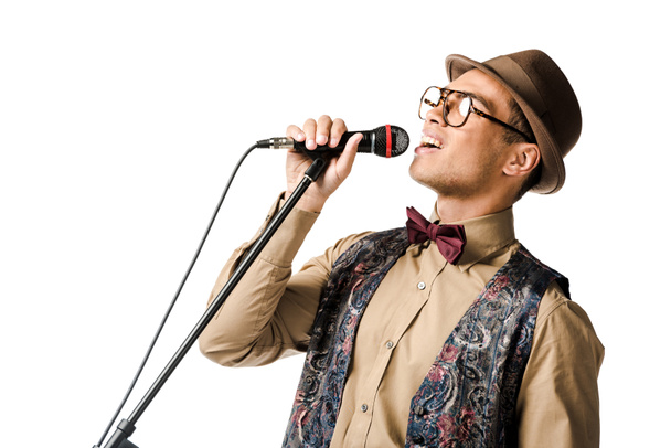 close up shot of emotional stylish mixed race male musician holding microphone and singing isolated on white - Φωτογραφία, εικόνα