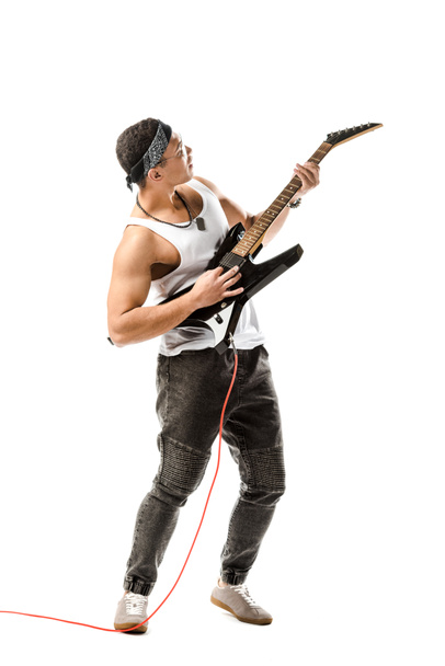 young male rock musician playing on electric guitar isolated on white - Foto, Bild