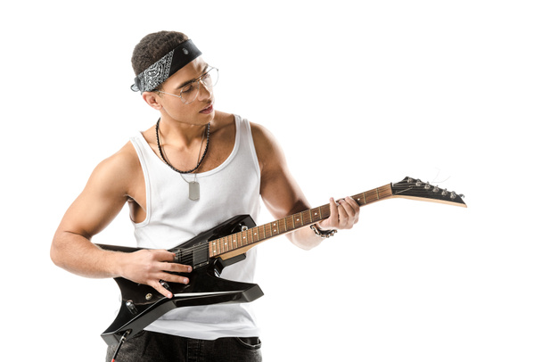 focused mixed race male rock musician playing on electric guitar isolated on white - Foto, Imagem