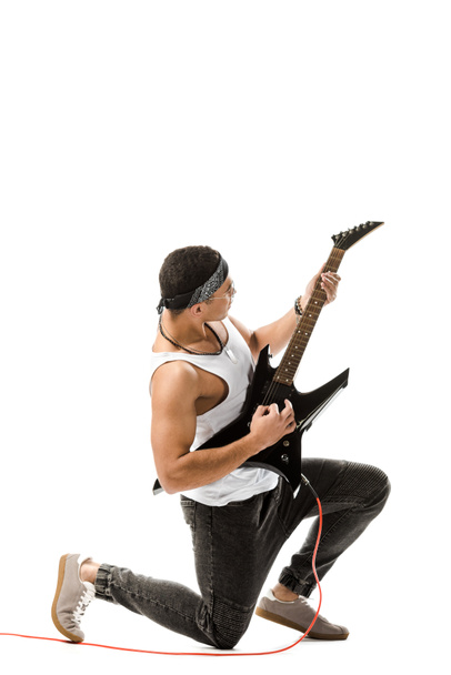 young mixed race rocker playing on electric guitar isolated on white - Fotó, kép