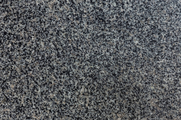Granite texture for background. Natural granite surface pattern as background. Stone wall of natural granite, abstract surface with gravel rock background. Natural treated stone with black and gray spots for decorating architecture - Photo, Image