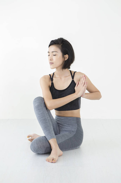 Young Asian woman hands together with her eyes closed - Photo, image